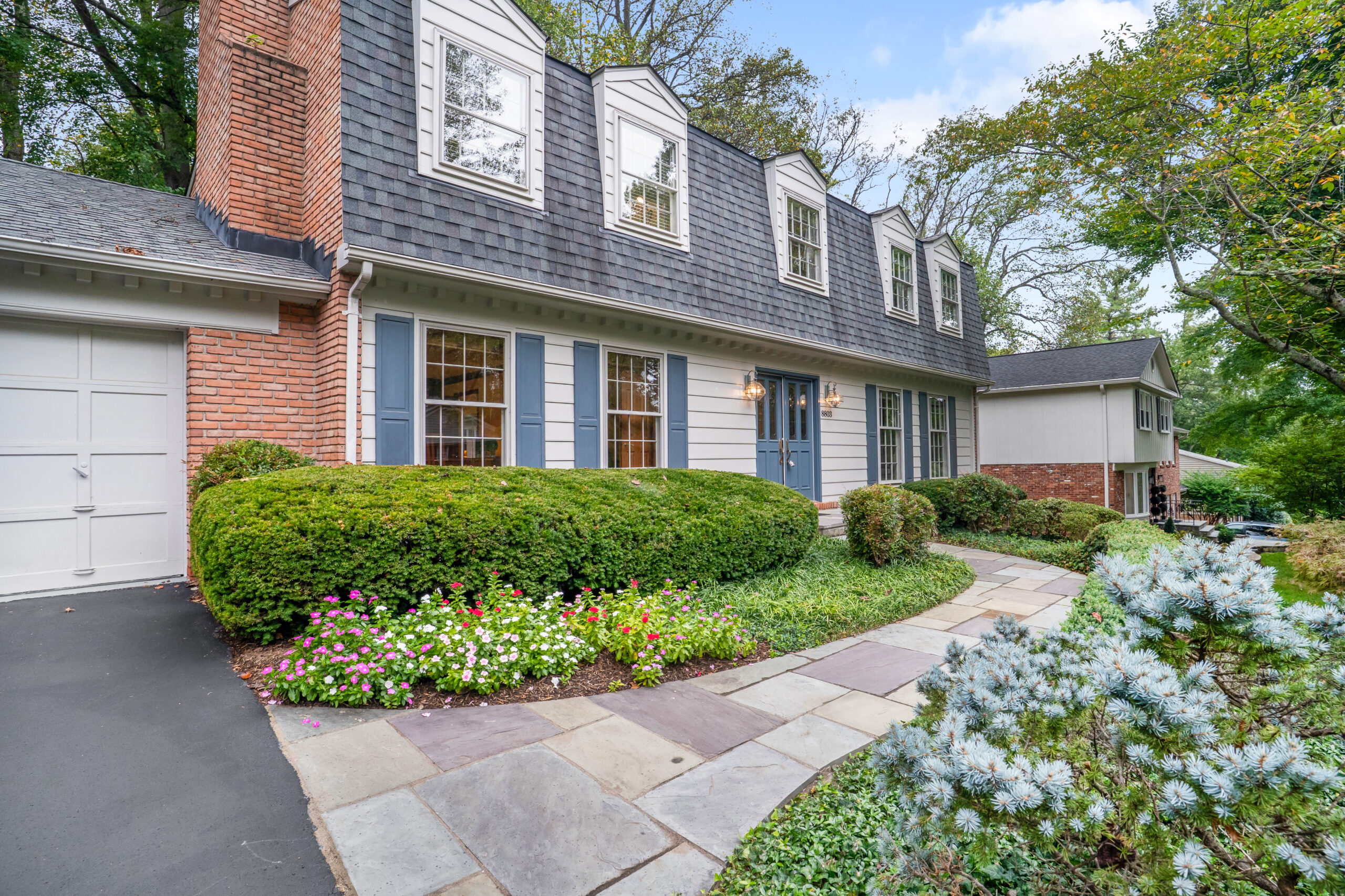 Colonial home exterior with mature landscaping