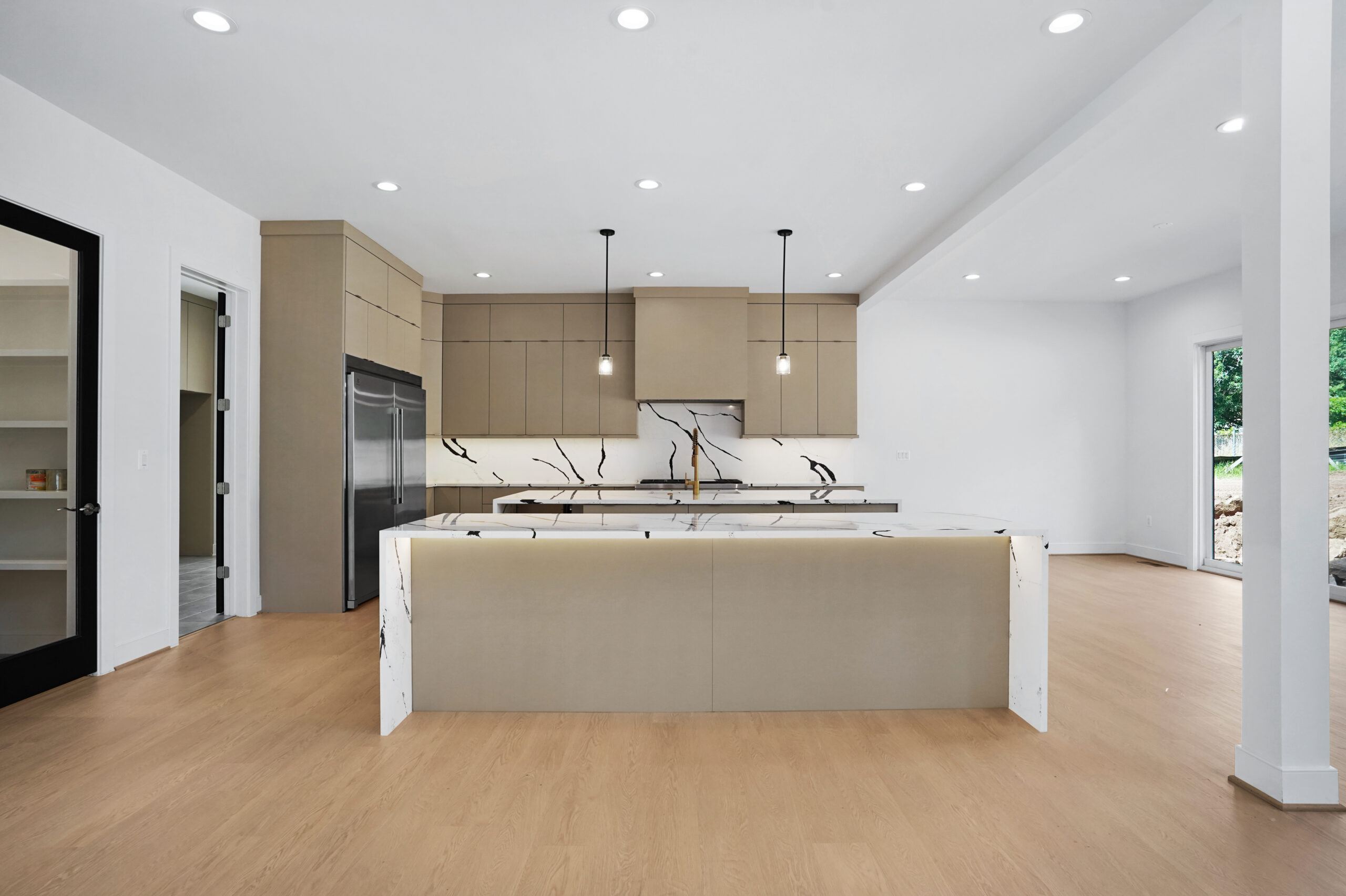 Modern kitchen with sculptural island and pendant lights