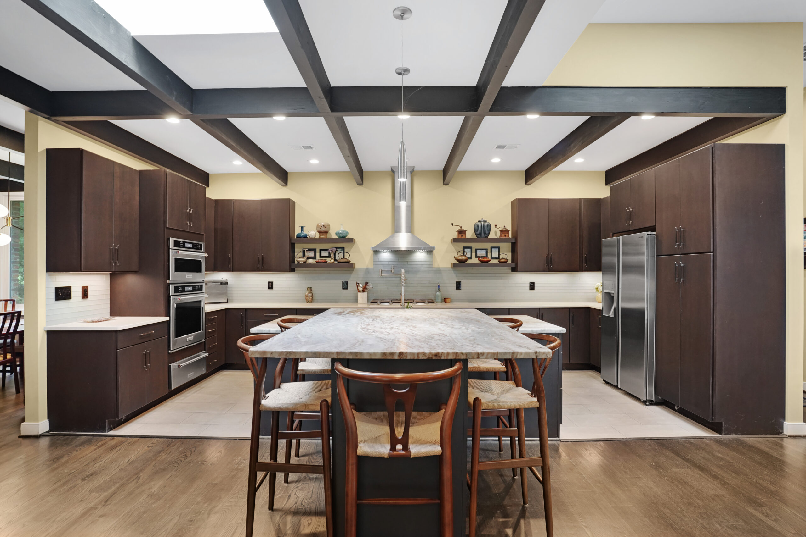 Large kitchen with exposed beams and island seating