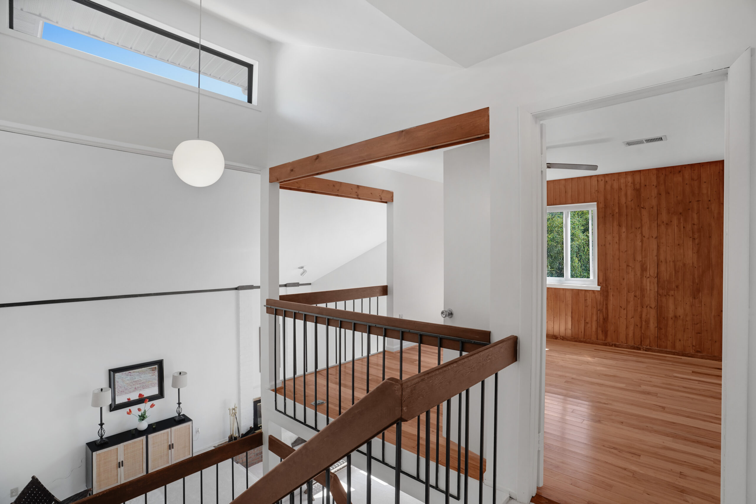 Mid-century interior with open stair and warm wood details
